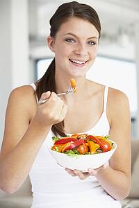 Young Woman Eating A Healthy Salad