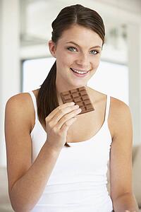 Young Woman Eating Chocolate