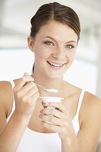 Young Woman Eating Yogurt