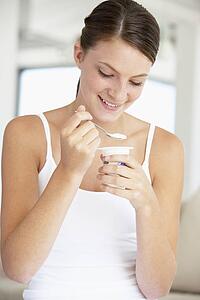 Young Woman Eating Yogurt