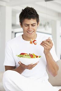 Young Man Eating A Salad