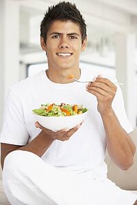 Young Man Eating A Salad