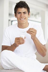Young Man Eating Yogurt