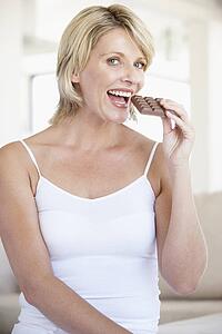 Mid Adult Woman Eating Chocolate