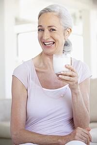 Senior Woman Drinking A Glass Of Milk