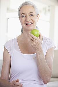 Senior Woman Eating Green Apple