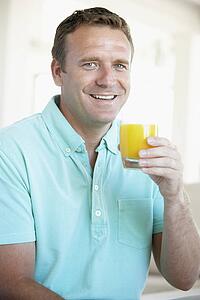 Mid Adult Man Drinking Orange Juice