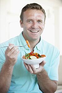 Mid Adult Man Eating A Salad