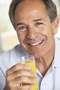 Middle Aged Man Drinking Fresh Orange Juice