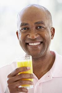 Middle Aged Man Drinking Fresh Orange Juice