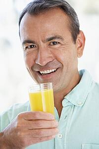 Middle Aged Man Drinking Fresh Orange Juice