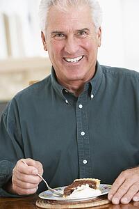 Senior Man Eating Chocolate Cake