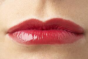 Extreme Close-Up Of Young Woman Wearing Red Lipstick