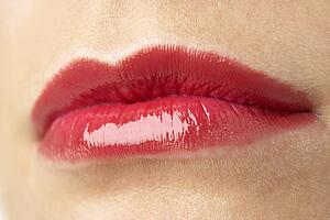 Extreme Close-Up Of Young Woman Wearing Red Lipstick