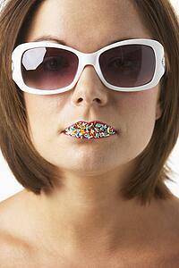 Young Woman Wearing Sunglasses With Sprinkles On Her Lips
