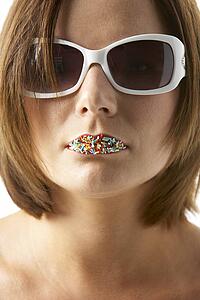Young Woman Wearing Sunglasses With Sprinkles On Her Lips
