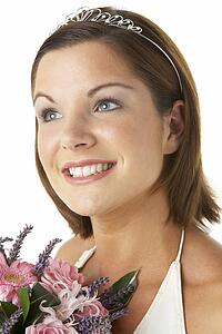 Portrait Of Bride Holding Bouquet Of Flowers
