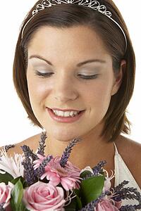 Portrait Of Bride Holding Bouquet Of Flowers
