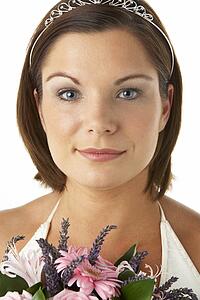 Portrait Of Bride Holding Bouquet Of Flowers