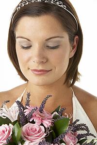 Portrait Of Bride Holding Bouquet Of Flowers