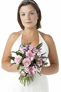 Portrait Of Bride Holding Bouquet Of Flowers