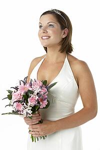 Portrait Of Bride Holding Bouquet Of Flowers