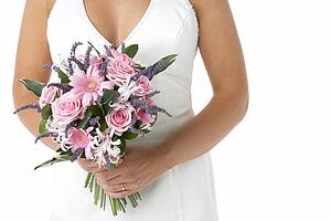 Bride Holding Bouquet Of Flowers