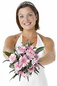 Portrait Of Bride Holding Bouquet Of Flowers