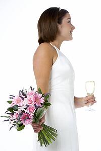 Portrait Of Bride Holding Bouquet And Wine Glass