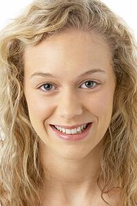 Portrait Of Young Woman Smiling At The Camera