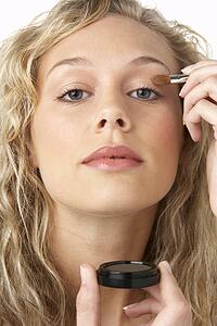 Young Woman Applying Make-Up