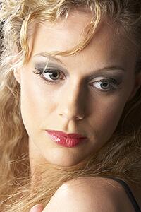 Young Woman Wearing Make-Up, Looking Thoughtful