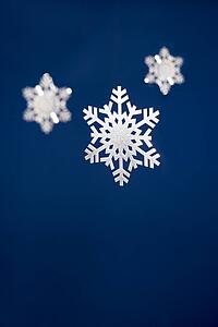 Snowflake Tree Decorations Against Blue Background