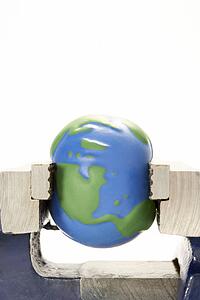 Model Earth Squeezed In Vice