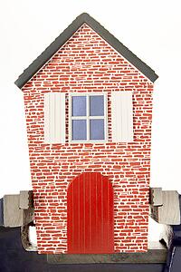 House Squeezed In Vice Against White Background