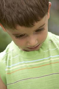 Portrait Of Young Boy Looking Down