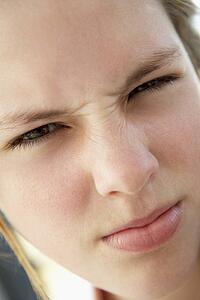 Portrait Of Teenage Girl Frowning