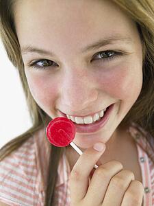 Portrait Of Teenage Girl Eating Lollipop