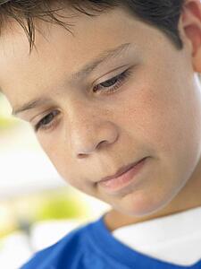 Portrait Of Boy Looking Unhappy