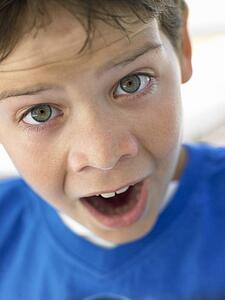 Portrait Of Boy Looking Surprised