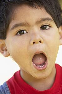 Portrait Of Boy Looking Surprised