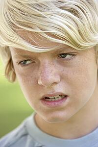 Portrait Of Teenage Boy Looking Angry