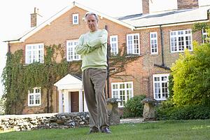 Senior Man Standing Outside House