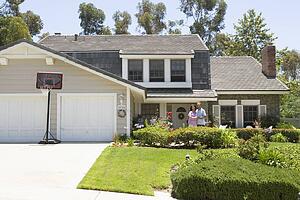 Couple Standing Outside Their House