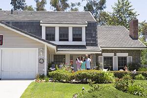 Family Waving Outside House