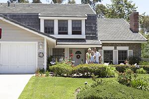 Family Standing Outside House