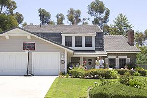 Couple Standing Outside Their House