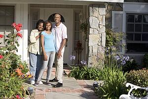 Family Standing Outside House