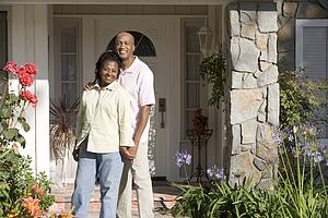 Couple Standing Outside Their House