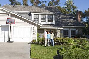 Family Standing Outside House